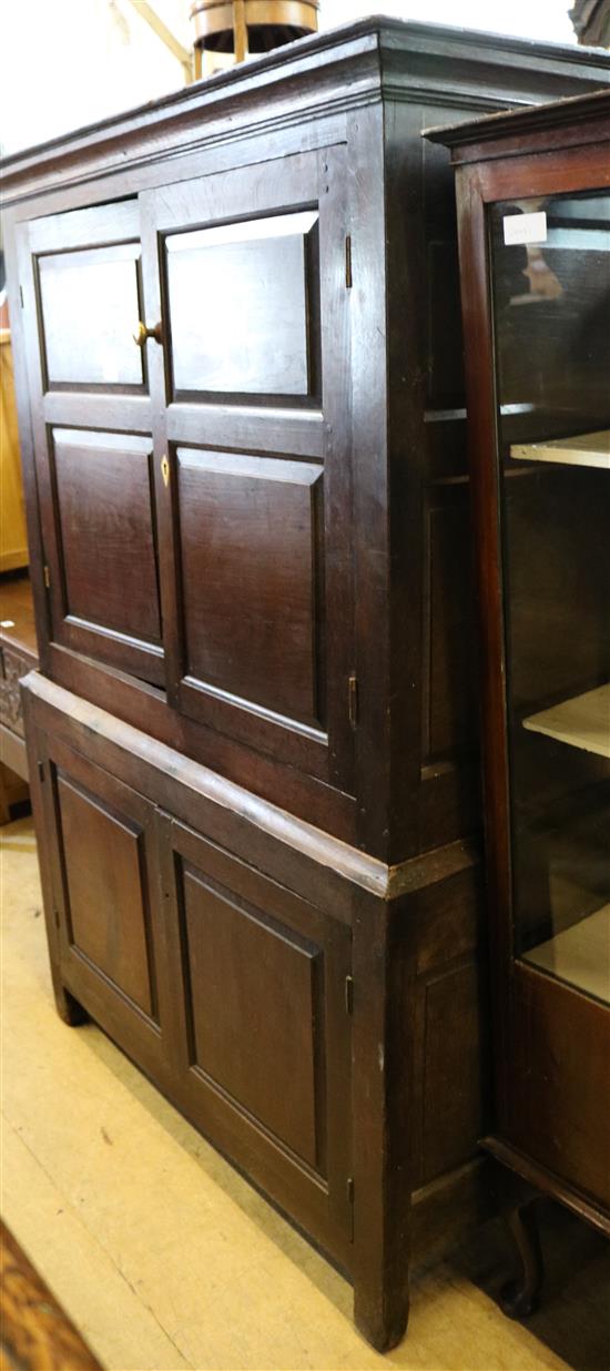 Mid 18C oak two part cupboard, enclosed by fielded panelled doors